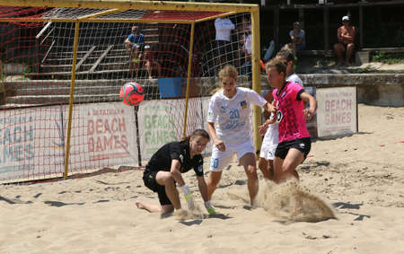 ODESSA, UKRAINE July 8, 2021: Ukrainian Beach Soccer Women's Cup. The girl's footballers are desperately playing beach soccer on sand of sea city beach on a hot sunny day. Women's soccer on sandのeditorial素材