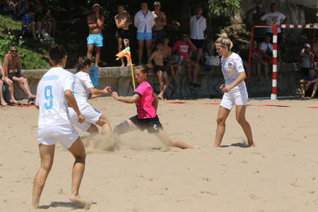ODESSA, UKRAINE July 8, 2021: Ukrainian Beach Soccer Women's Cup. The girl's footballers are desperately playing beach soccer on sand of sea city beach on a hot sunny day. Women's soccer on sandのeditorial素材