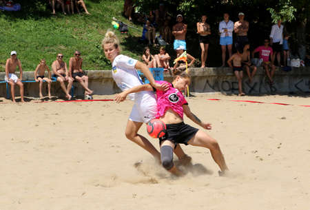 ODESSA, UKRAINE July 8, 2021: Ukrainian Beach Soccer Women's Cup. The girl's footballers are desperately playing beach soccer on sand of sea city beach on a hot sunny day. Women's soccer on sandのeditorial素材