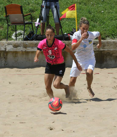 ODESSA, UKRAINE July 8, 2021: Ukrainian Beach Soccer Women's Cup. The girl's footballers are desperately playing beach soccer on sand of sea city beach on a hot sunny day. Women's soccer on sandのeditorial素材