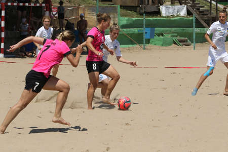 ODESSA, UKRAINE July 8, 2021: Ukrainian Beach Soccer Women's Cup. The girl's footballers are desperately playing beach soccer on sand of sea city beach on a hot sunny day. Women's soccer on sandのeditorial素材