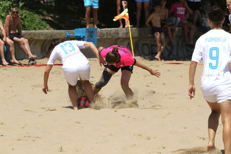 ODESSA, UKRAINE July 8, 2021: Ukrainian Beach Soccer Women's Cup. The girl's footballers are desperately playing beach soccer on sand of sea city beach on a hot sunny day. Women's soccer on sandのeditorial素材