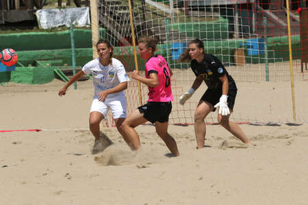 ODESSA, UKRAINE July 8, 2021: Ukrainian Beach Soccer Women's Cup. The girl's footballers are desperately playing beach soccer on sand of sea city beach on a hot sunny day. Women's soccer on sandのeditorial素材