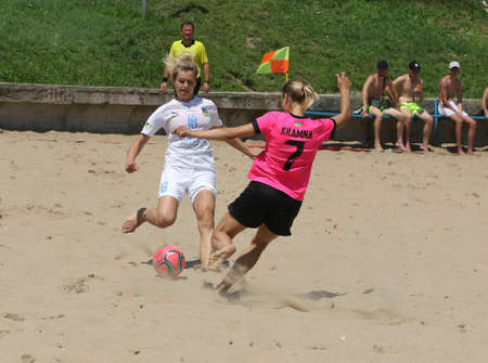 ODESSA, UKRAINE July 8, 2021: Ukrainian Beach Soccer Women's Cup. The girl's footballers are desperately playing beach soccer on sand of sea city beach on a hot sunny day. Women's soccer on sandのeditorial素材