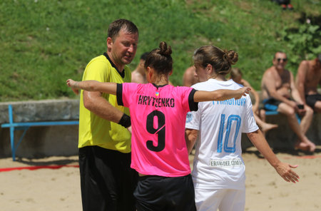 ODESSA, UKRAINE July 8, 2021: Ukrainian Beach Soccer Women's Cup. The girl's footballers are desperately playing beach soccer on sand of sea city beach on a hot sunny day. Women's soccer on sandのeditorial素材