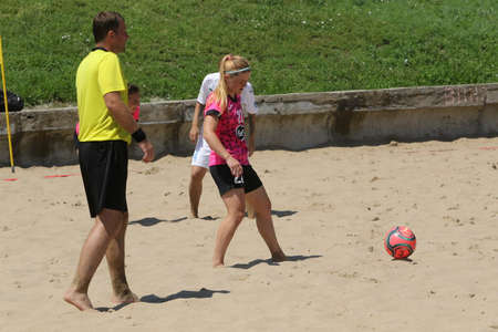 ODESSA, UKRAINE July 8, 2021: Ukrainian Beach Soccer Women's Cup. The girl's footballers are desperately playing beach soccer on sand of sea city beach on a hot sunny day. Women's soccer on sandのeditorial素材