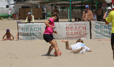 ODESSA, UKRAINE July 8, 2021: Ukrainian Beach Soccer Women's Cup. The girl's footballers are desperately playing beach soccer on sand of sea city beach on a hot sunny day. Women's soccer on sandのeditorial素材