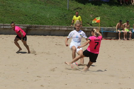 ODESSA, UKRAINE July 8, 2021: Ukrainian Beach Soccer Women's Cup. The girl's footballers are desperately playing beach soccer on sand of sea city beach on a hot sunny day. Women's soccer on sandのeditorial素材