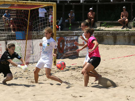 ODESSA, UKRAINE July 8, 2021: Ukrainian Beach Soccer Women's Cup. The girl's footballers are desperately playing beach soccer on sand of sea city beach on a hot sunny day. Women's soccer on sandのeditorial素材