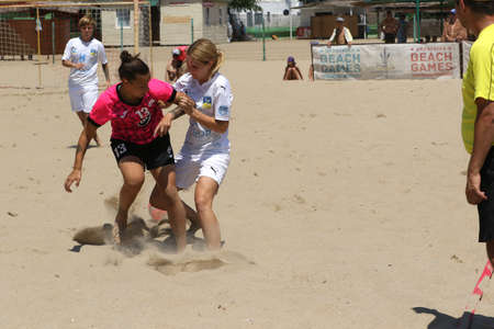 ODESSA, UKRAINE July 8, 2021: Ukrainian Beach Soccer Women's Cup. The girl's footballers are desperately playing beach soccer on sand of sea city beach on a hot sunny day. Women's soccer on sandのeditorial素材
