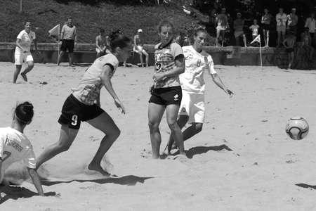 ODESSA, UKRAINE July 8, 2021: Ukrainian Beach Soccer Women's Cup. The girl's footballers are desperately playing beach soccer on sand of sea city beach on a hot sunny day. Women's soccer on sandのeditorial素材
