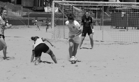 ODESSA, UKRAINE July 8, 2021: Ukrainian Beach Soccer Women's Cup. The girl's footballers are desperately playing beach soccer on sand of sea city beach on a hot sunny day. Women's soccer on sandのeditorial素材