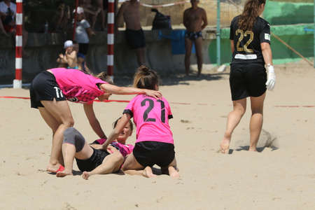 ODESSA, UKRAINE July 8, 2021: Ukrainian Beach Soccer Women's Cup. The girl's footballers are desperately playing beach soccer on sand of sea city beach on a hot sunny day. Women's soccer on sandのeditorial素材