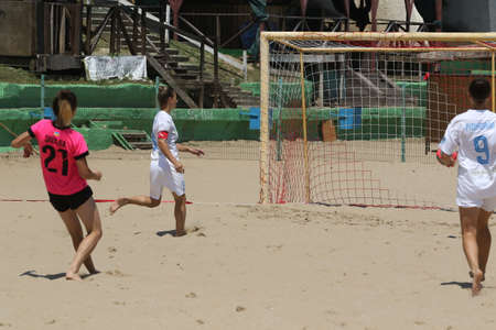 ODESSA, UKRAINE July 8, 2021: Ukrainian Beach Soccer Women's Cup. The girl's footballers are desperately playing beach soccer on sand of sea city beach on a hot sunny day. Women's soccer on sandのeditorial素材