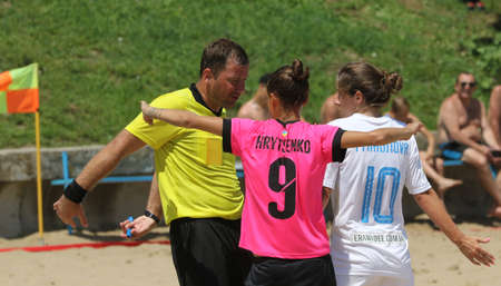 ODESSA, UKRAINE July 8, 2021: Ukrainian Beach Soccer Women's Cup. The girl's footballers are desperately playing beach soccer on sand of sea city beach on a hot sunny day. Women's soccer on sandのeditorial素材