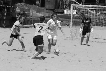 ODESSA, UKRAINE July 8, 2021: Ukrainian Beach Soccer Women's Cup. The girl's footballers are desperately playing beach soccer on sand of sea city beach on a hot sunny day. Women's soccer on sandのeditorial素材