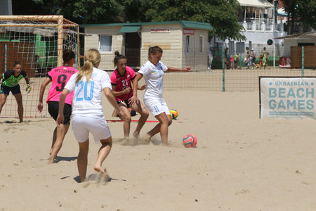 ODESSA, UKRAINE July 8, 2021: Ukrainian Beach Soccer Women's Cup. The girl's footballers are desperately playing beach soccer on sand of sea city beach on a hot sunny day. Women's soccer on sandのeditorial素材