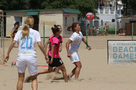 ODESSA, UKRAINE July 8, 2021: Ukrainian Beach Soccer Women's Cup. The girl's footballers are desperately playing beach soccer on sand of sea city beach on a hot sunny day. Women's soccer on sandのeditorial素材