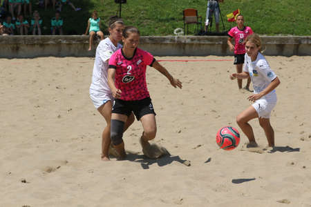 ODESSA, UKRAINE July 8, 2021: Ukrainian Beach Soccer Women's Cup. The girl's footballers are desperately playing beach soccer on sand of sea city beach on a hot sunny day. Women's soccer on sandのeditorial素材