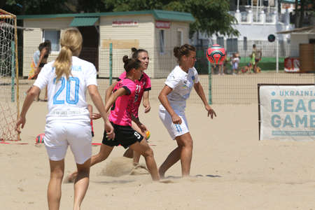 ODESSA, UKRAINE July 8, 2021: Ukrainian Beach Soccer Women's Cup. The girl's footballers are desperately playing beach soccer on sand of sea city beach on a hot sunny day. Women's soccer on sandのeditorial素材
