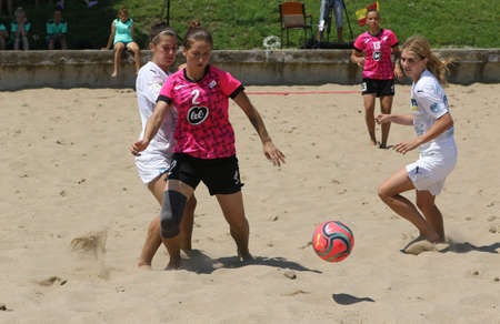 ODESSA, UKRAINE July 8, 2021: Ukrainian Beach Soccer Women's Cup. The girl's footballers are desperately playing beach soccer on sand of sea city beach on a hot sunny day. Women's soccer on sandのeditorial素材
