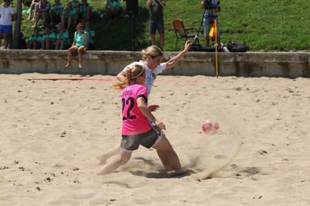 ODESSA, UKRAINE July 8, 2021: Ukrainian Beach Soccer Women's Cup. The girl's footballers are desperately playing beach soccer on sand of sea city beach on a hot sunny day. Women's soccer on sandのeditorial素材