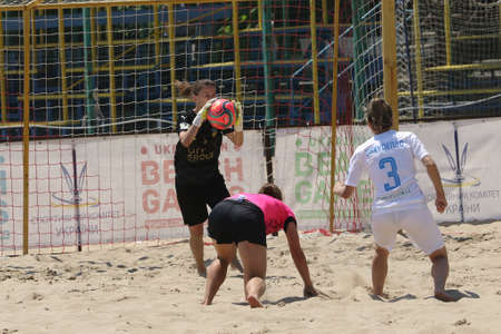 ODESSA, UKRAINE July 8, 2021: Ukrainian Beach Soccer Women's Cup. The girl's footballers are desperately playing beach soccer on sand of sea city beach on a hot sunny day. Women's soccer on sandのeditorial素材