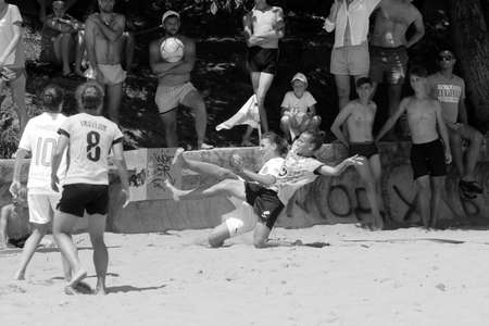 ODESSA, UKRAINE July 8, 2021: Ukrainian Beach Soccer Women's Cup. The girl's footballers are desperately playing beach soccer on sand of sea city beach on a hot sunny day. Women's soccer on sandのeditorial素材