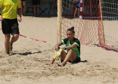 ODESSA, UKRAINE July 8, 2021: Ukrainian Beach Soccer Women's Cup. The girl's footballers are desperately playing beach soccer on sand of sea city beach on a hot sunny day. Women's soccer on sandのeditorial素材