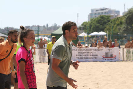 ODESSA, UKRAINE July 8, 2021: Ukrainian Beach Soccer Women's Cup. The girl's footballers are desperately playing beach soccer on sand of sea city beach on a hot sunny day. Women's soccer on sandのeditorial素材