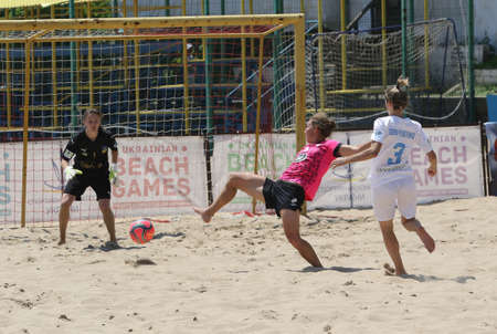 ODESSA, UKRAINE July 8, 2021: Ukrainian Beach Soccer Women's Cup. The girl's footballers are desperately playing beach soccer on sand of sea city beach on a hot sunny day. Women's soccer on sandのeditorial素材