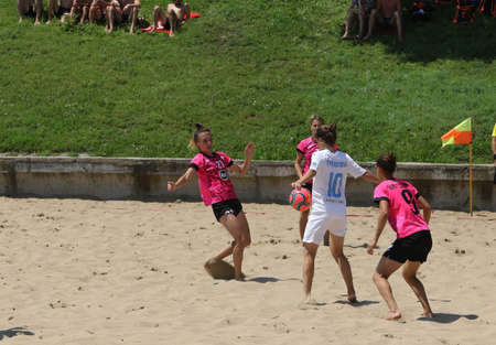 ODESSA, UKRAINE July 8, 2021: Ukrainian Beach Soccer Women's Cup. The girl's footballers are desperately playing beach soccer on sand of sea city beach on a hot sunny day. Women's soccer on sandのeditorial素材
