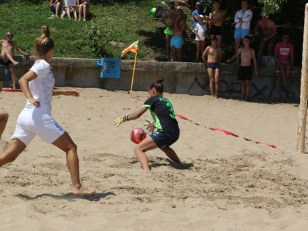 ODESSA, UKRAINE July 8, 2021: Ukrainian Beach Soccer Women's Cup. The girl's footballers are desperately playing beach soccer on sand of sea city beach on a hot sunny day. Women's soccer on sandのeditorial素材