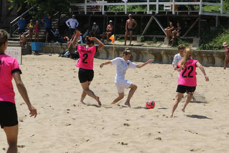 ODESSA, UKRAINE July 8, 2021: Ukrainian Beach Soccer Women's Cup. The girl's footballers are desperately playing beach soccer on sand of sea city beach on a hot sunny day. Women's soccer on sandのeditorial素材