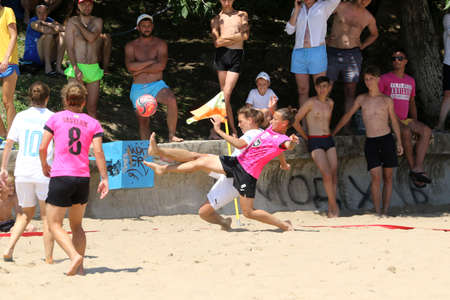 ODESSA, UKRAINE July 8, 2021: Ukrainian Beach Soccer Women's Cup. The girl's footballers are desperately playing beach soccer on sand of sea city beach on a hot sunny day. Women's soccer on sandのeditorial素材