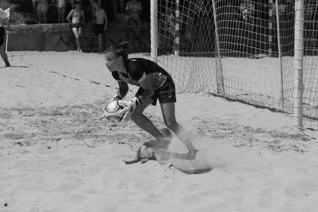 ODESSA, UKRAINE July 8, 2021: Ukrainian Beach Soccer Women's Cup. The girl's footballers are desperately playing beach soccer on sand of sea city beach on a hot sunny day. Women's soccer on sandのeditorial素材