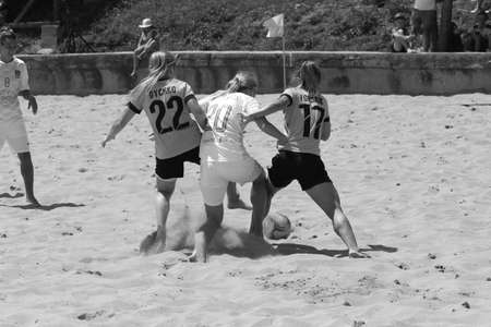 ODESSA, UKRAINE July 8, 2021: Ukrainian Beach Soccer Women's Cup. The girl's footballers are desperately playing beach soccer on sand of sea city beach on a hot sunny day. Women's soccer on sandのeditorial素材