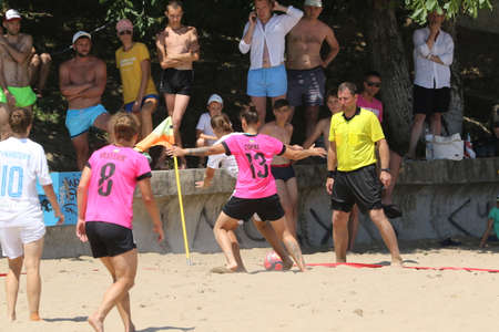ODESSA, UKRAINE July 8, 2021: Ukrainian Beach Soccer Women's Cup. The girl's footballers are desperately playing beach soccer on sand of sea city beach on a hot sunny day. Women's soccer on sandのeditorial素材