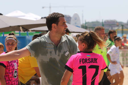 ODESSA, UKRAINE July 8, 2021: Ukrainian Beach Soccer Women's Cup. The girl's footballers are desperately playing beach soccer on sand of sea city beach on a hot sunny day. Women's soccer on sandのeditorial素材