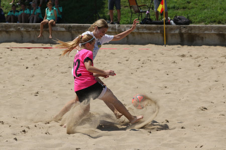 ODESSA, UKRAINE July 8, 2021: Ukrainian Beach Soccer Women's Cup. The girl's footballers are desperately playing beach soccer on sand of sea city beach on a hot sunny day. Women's soccer on sandのeditorial素材