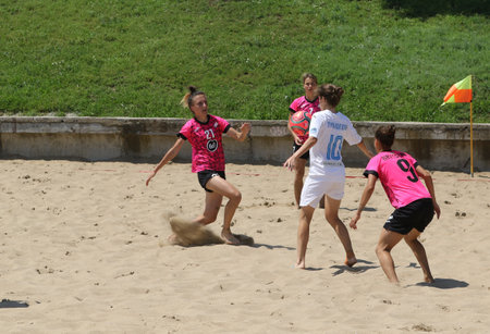 ODESSA, UKRAINE July 8, 2021: Ukrainian Beach Soccer Women's Cup. The girl's footballers are desperately playing beach soccer on sand of sea city beach on a hot sunny day. Women's soccer on sandのeditorial素材
