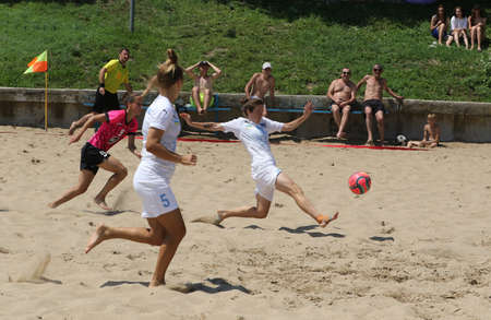 ODESSA, UKRAINE July 8, 2021: Ukrainian Beach Soccer Women's Cup. The girl's footballers are desperately playing beach soccer on sand of sea city beach on a hot sunny day. Women's soccer on sandのeditorial素材