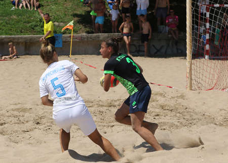 ODESSA, UKRAINE July 8, 2021: Ukrainian Beach Soccer Women's Cup. The girl's footballers are desperately playing beach soccer on sand of sea city beach on a hot sunny day. Women's soccer on sandのeditorial素材