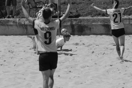 ODESSA, UKRAINE July 8, 2021: Ukrainian Beach Soccer Women's Cup. The girl's footballers are desperately playing beach soccer on sand of sea city beach on a hot sunny day. Women's soccer on sandのeditorial素材