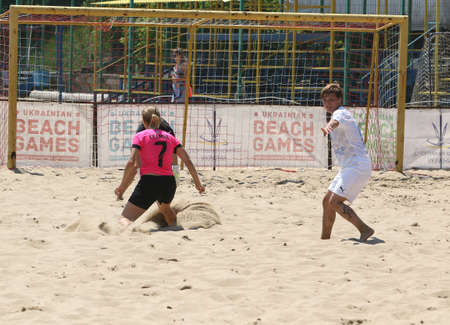 ODESSA, UKRAINE July 8, 2021: Ukrainian Beach Soccer Women's Cup. The girl's footballers are desperately playing beach soccer on sand of sea city beach on a hot sunny day. Women's soccer on sandのeditorial素材