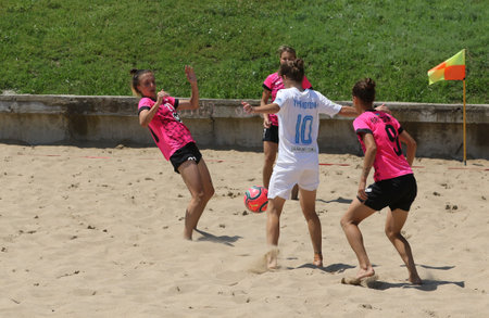 ODESSA, UKRAINE July 8, 2021: Ukrainian Beach Soccer Women's Cup. The girl's footballers are desperately playing beach soccer on sand of sea city beach on a hot sunny day. Women's soccer on sandのeditorial素材