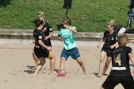 ODESSA, UKRAINE July 8, 2021: Ukrainian Beach Soccer Women's Cup. The girl's footballers are desperately playing beach soccer on sand of sea city beach on a hot sunny day. Women's soccer on sandのeditorial素材