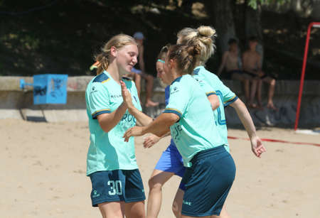 ODESSA, UKRAINE July 8, 2021: Ukrainian Beach Soccer Women's Cup. The girl's footballers are desperately playing beach soccer on sand of sea city beach on a hot sunny day. Women's soccer on sandのeditorial素材
