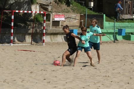 ODESSA, UKRAINE July 8, 2021: Ukrainian Beach Soccer Women's Cup. The girl's footballers are desperately playing beach soccer on sand of sea city beach on a hot sunny day. Women's soccer on sandのeditorial素材