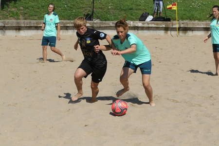 ODESSA, UKRAINE July 8, 2021: Ukrainian Beach Soccer Women's Cup. The girl's footballers are desperately playing beach soccer on sand of sea city beach on a hot sunny day. Women's soccer on sandのeditorial素材